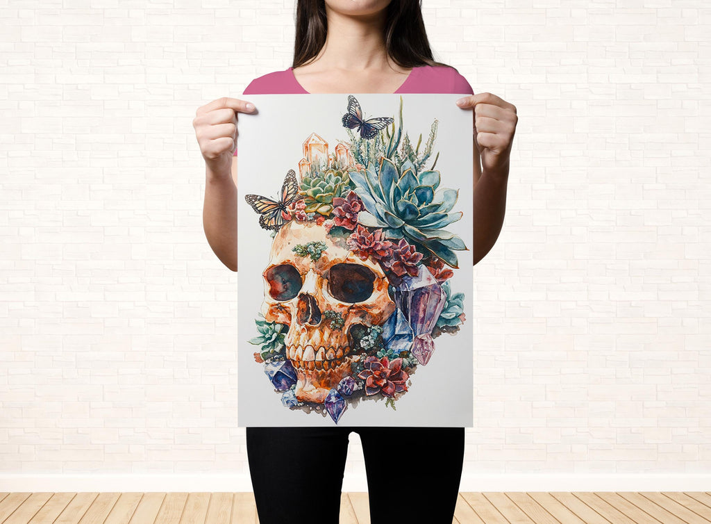 A woman holds up a poster featuring a colorful, artistic depiction of a skull surrounded by various floral and natural elements.