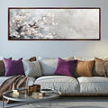 a living room with a couch and a painting on the wall