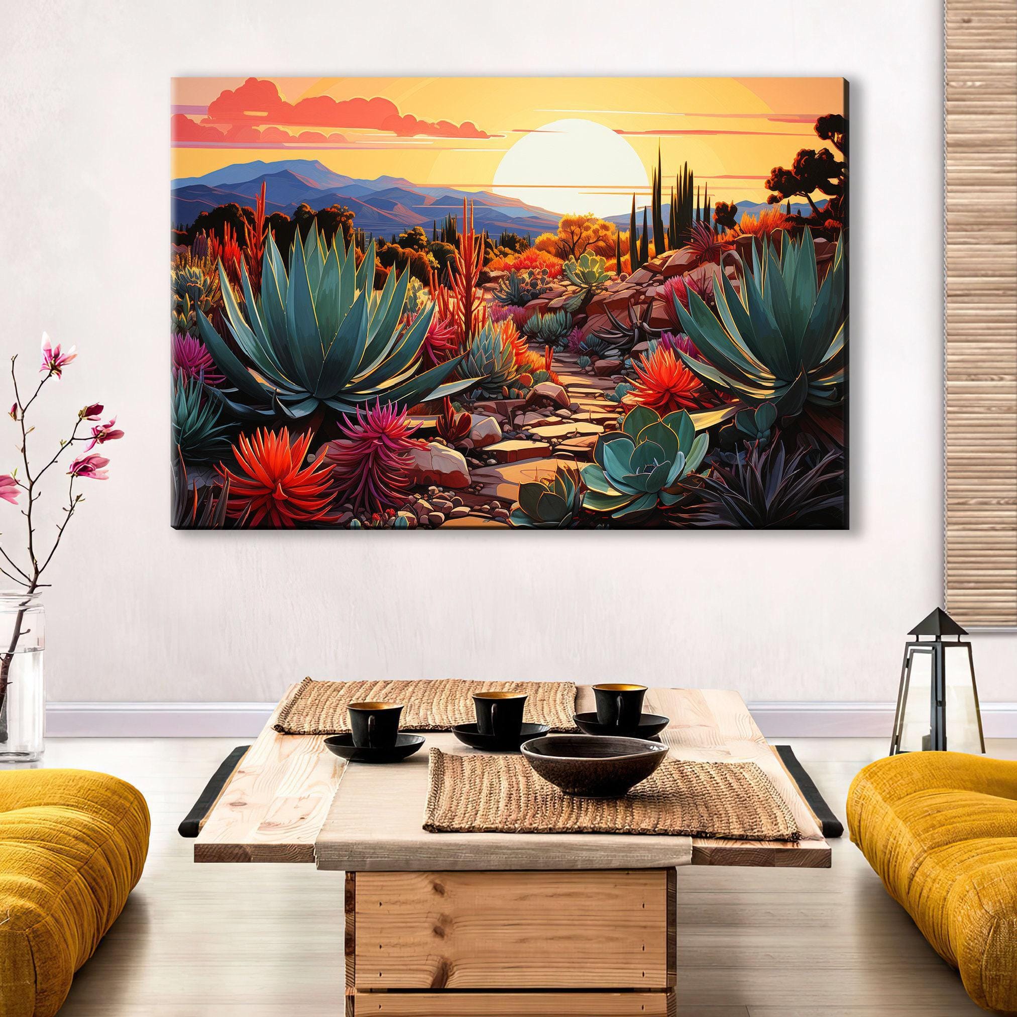 a large, colorful painting of a desert landscape with a sunset in the background, hanging on a wall above a wooden coffee table with a bowl and cups on it.
