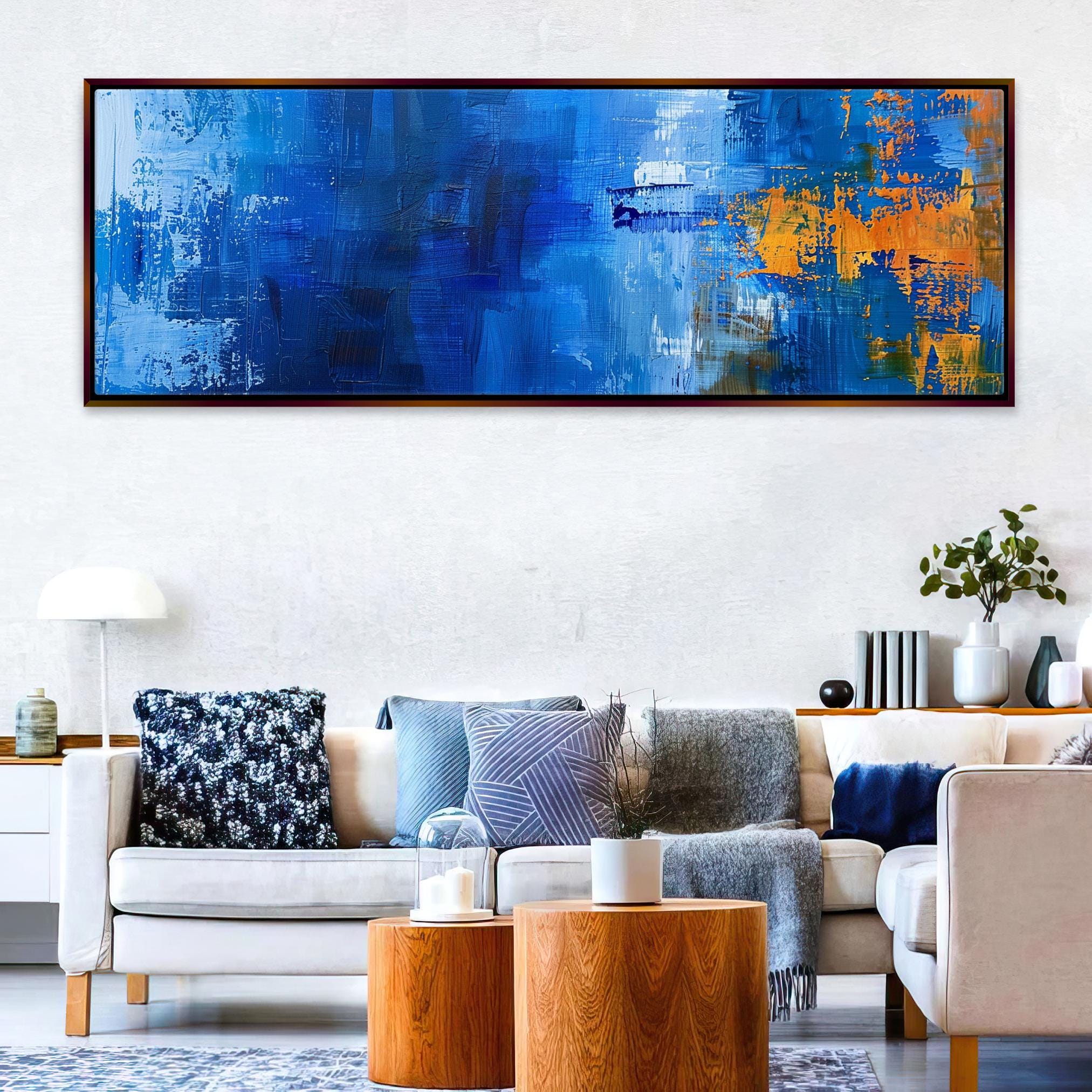 a living room filled with furniture and a painting on the wall