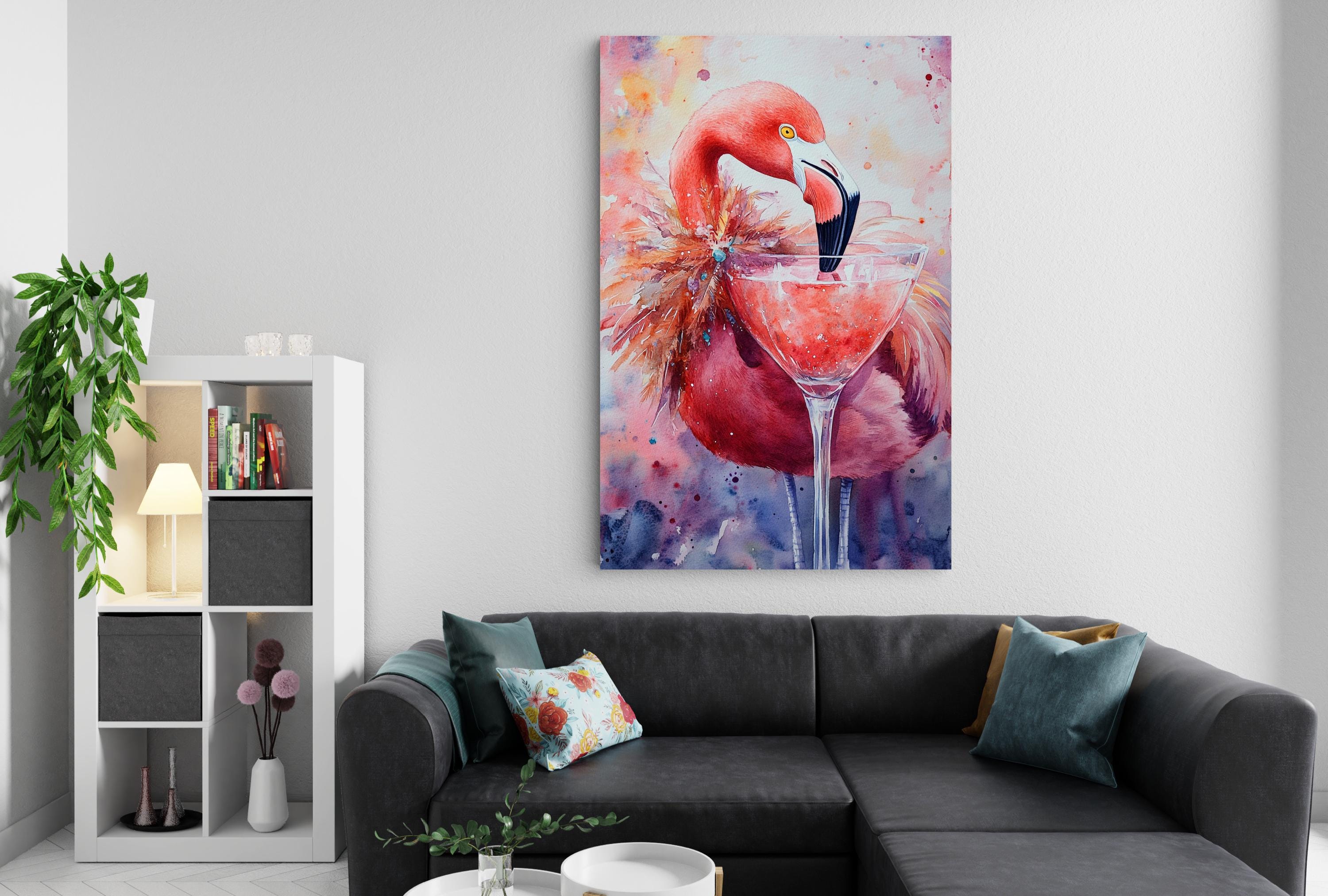 a large, colorful painting of a flamingo with a drink in its beak, hanging on a wall above a gray couch with throw pillows.