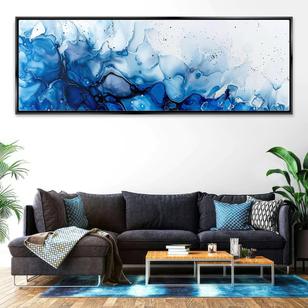 a living room with a couch and a painting on the wall
