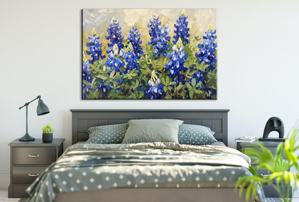 a bedroom with a large painting of blue flowers hanging above a bed with a gray and white patterned bedspread.