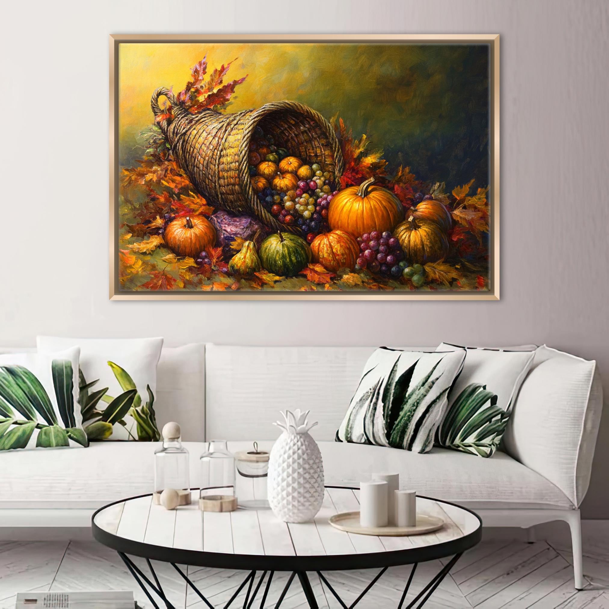 a large painting of a basket overflowing with various fruits, including apples, oranges, and pumpkins, set against a backdrop of autumn leaves. The painting is hung on a wall above a white couch with decorative pillows. In front of the couch, there is a coffee table with a vase, candles, and other decorative items.