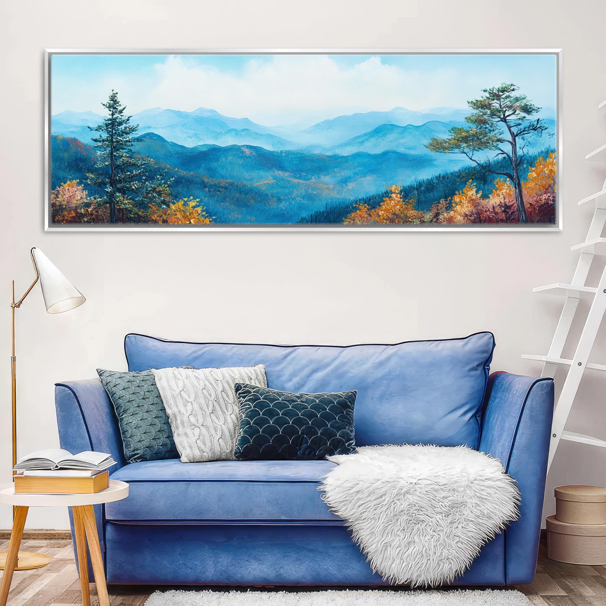 a living room with a blue couch and a painting on the wall