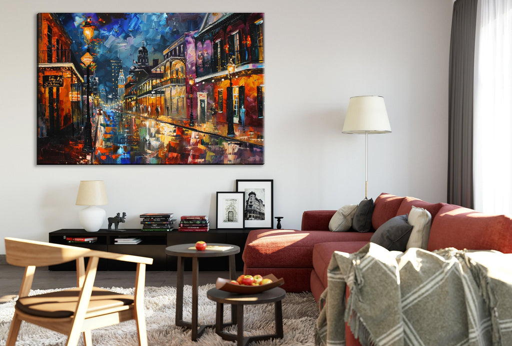 a cozy living room with a large, colorful painting of a city street hanging on the wall. The room is furnished with a red couch, a wooden chair, and a coffee table with a bowl of fruit. The overall atmosphere of the room is warm and inviting, with the painting adding a touch of vibrancy and color to the space.