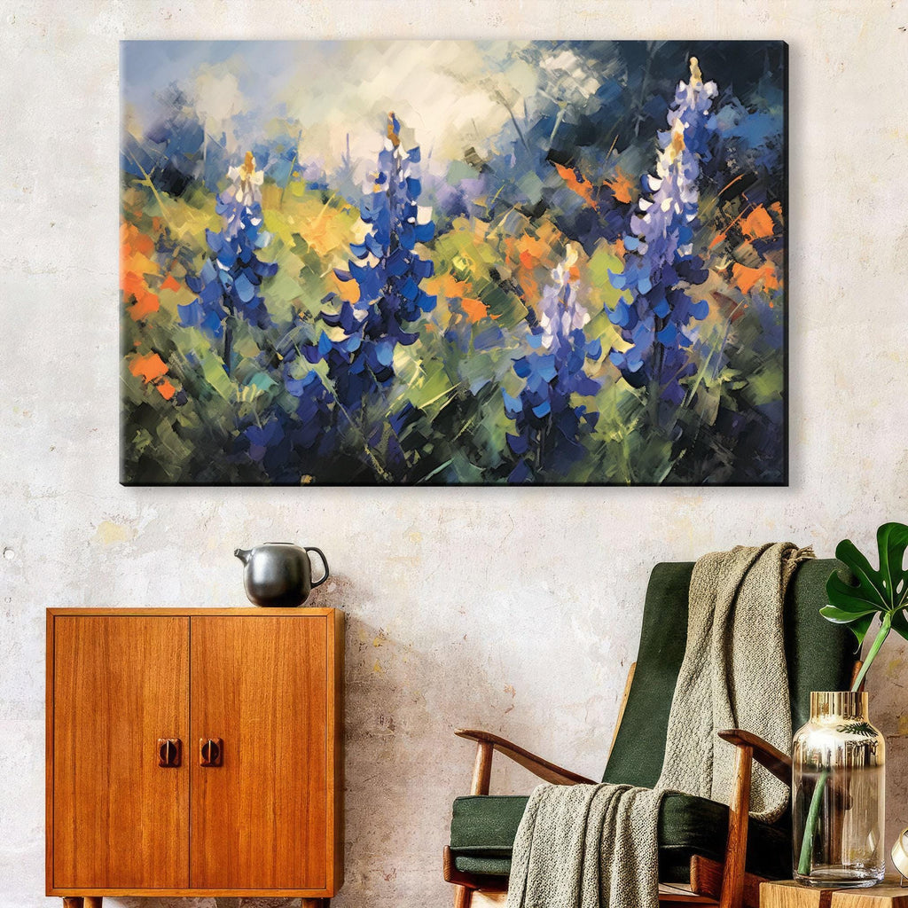 a large painting of blue and green flowers hanging on a wall above a wooden cabinet and a green armchair.