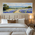 a bedroom with a large painting on the wall above the bed