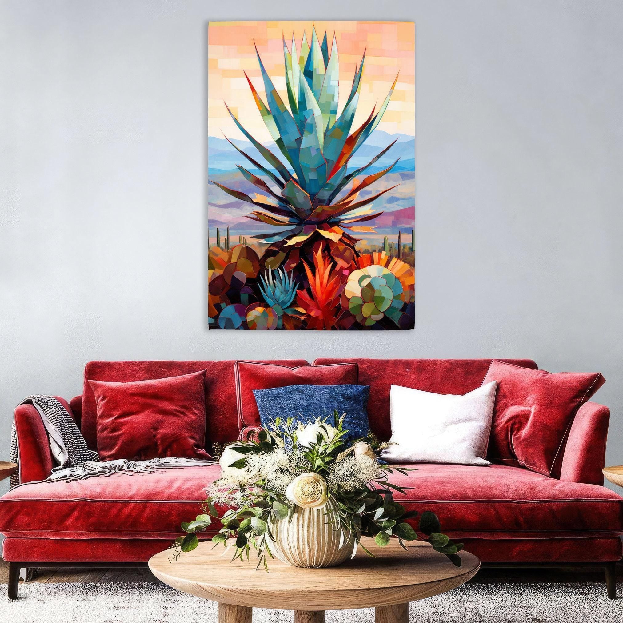 a vibrant, colorful painting of a cactus plant hanging on a wall above a red velvet sofa with a wooden coffee table in front of it.