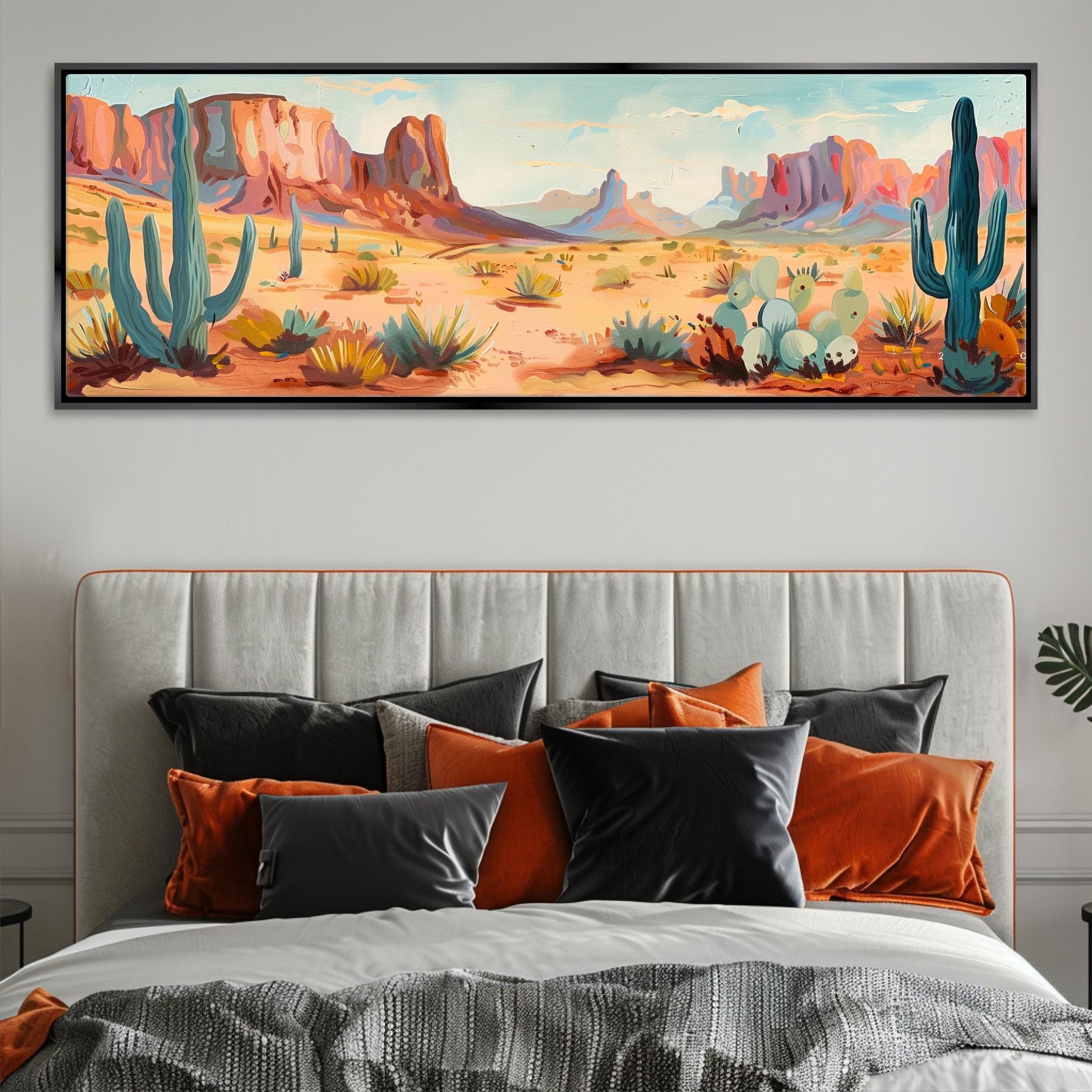 a painting of a desert scene on a wall above a bed