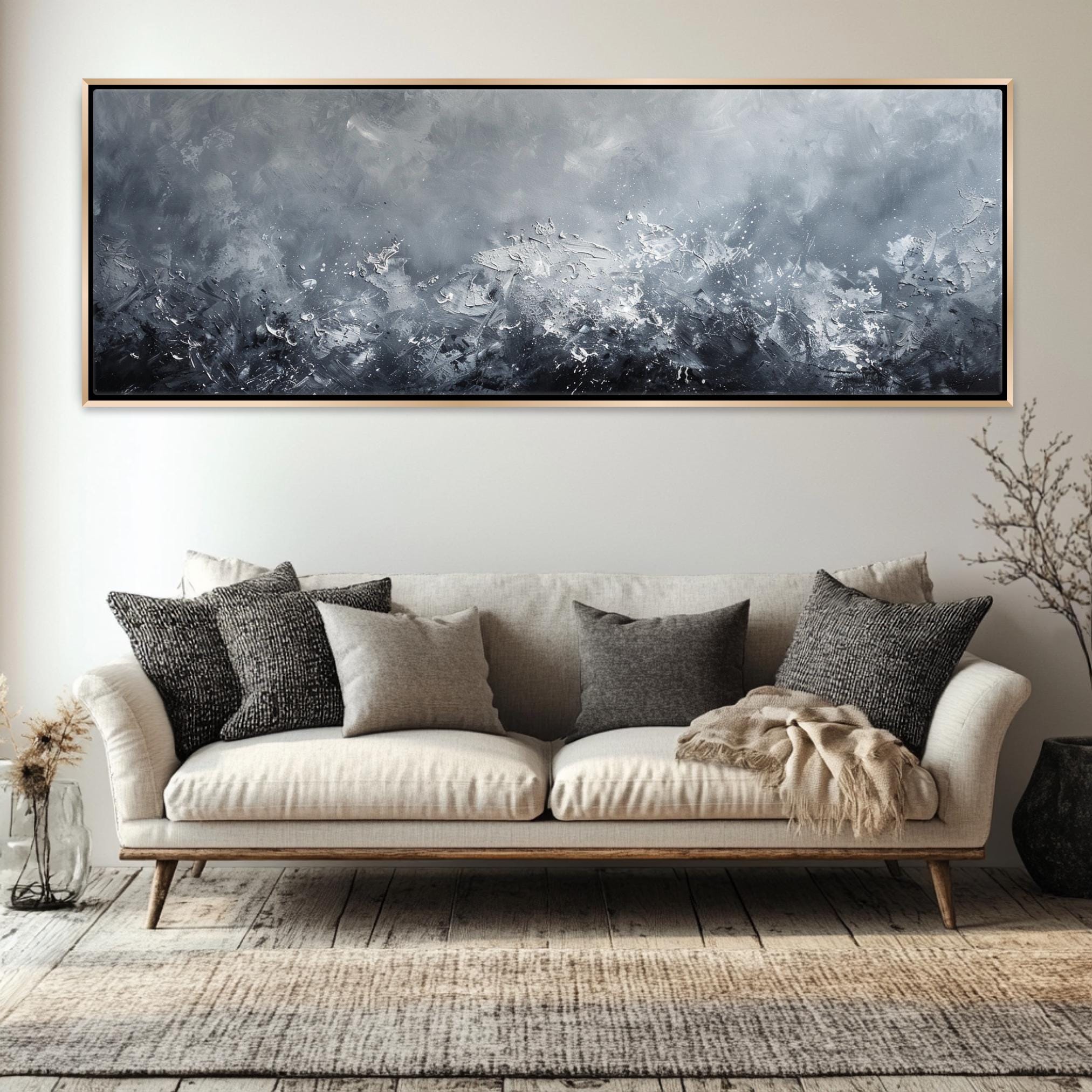 a living room with a couch and a painting on the wall