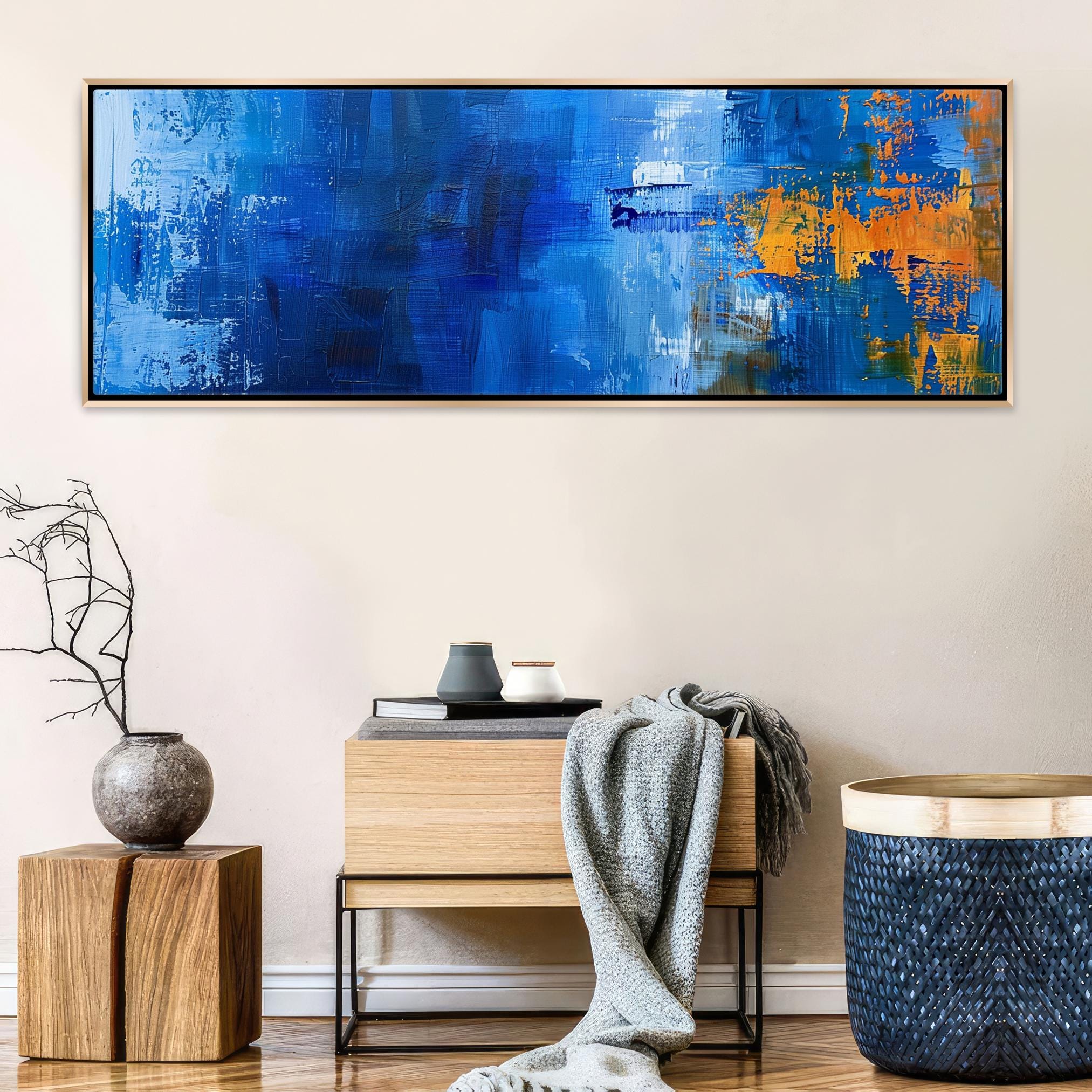 a living room with a blue painting on the wall