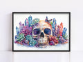 A framed watercolor painting depicting a skull surrounded by colorful crystals, succulents, and butterflies.
