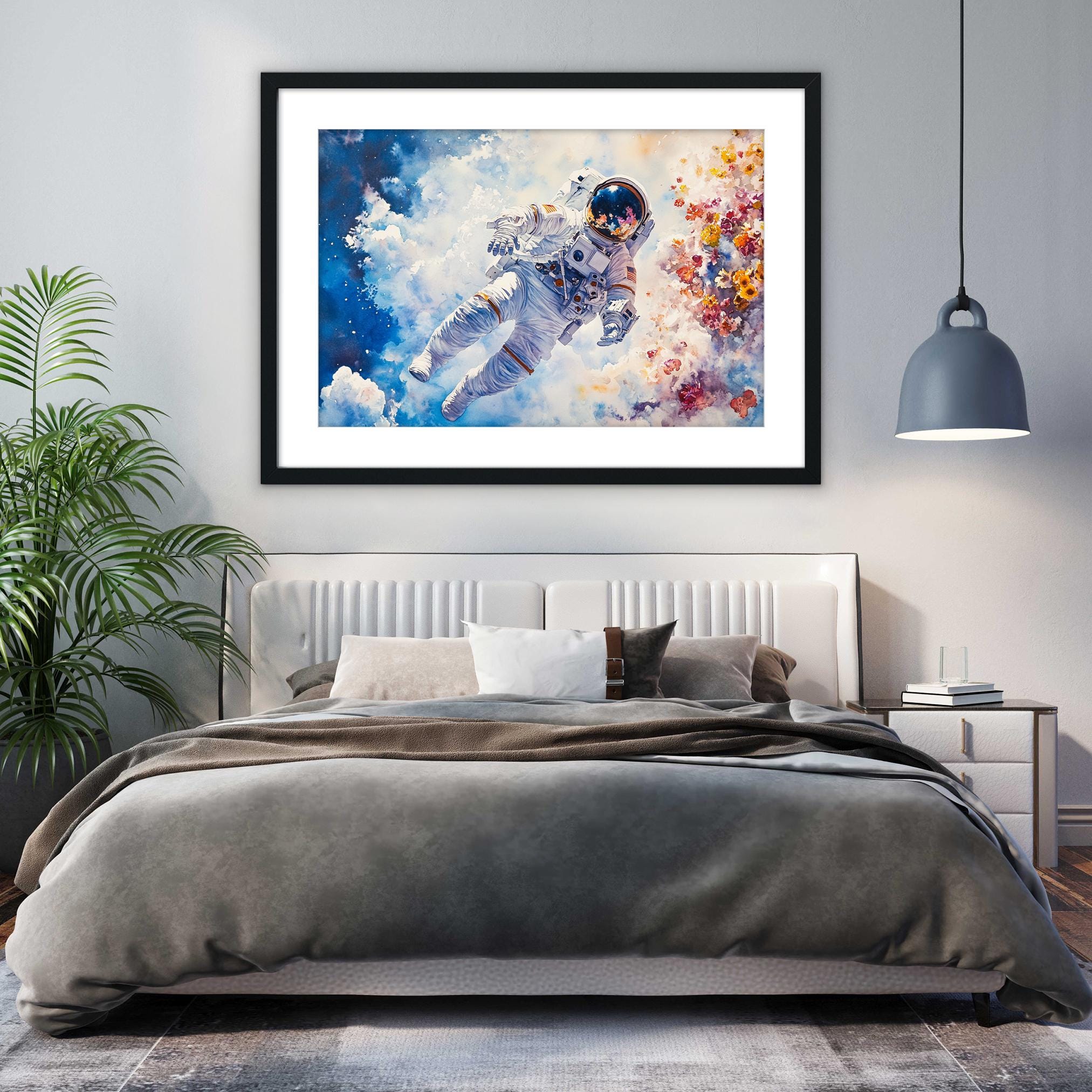 a bedroom with a large bed, a framed painting of an astronaut floating in space, and a potted plant on the left side of the room.