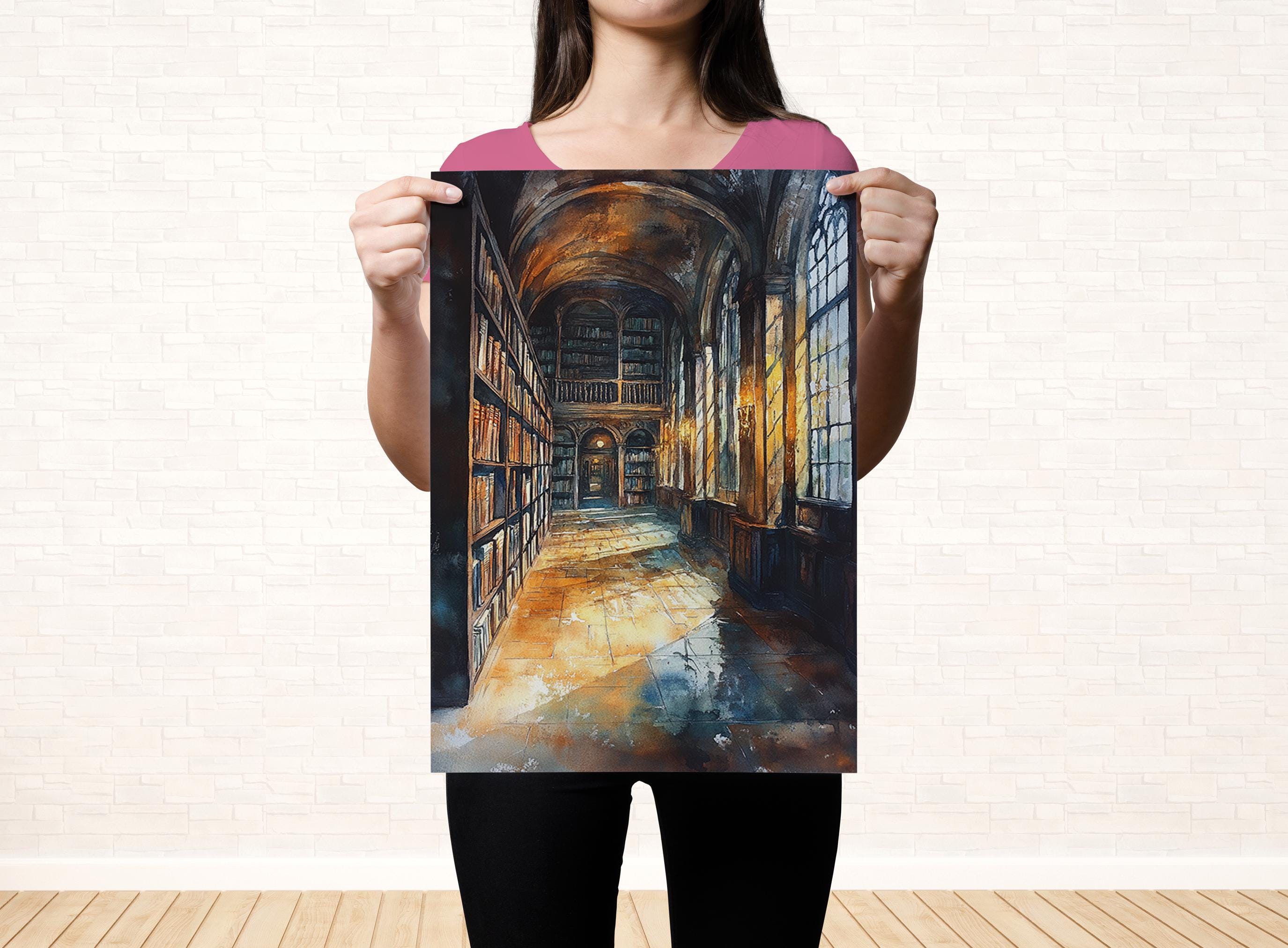 A woman holds up a framed painting depicting a grand library with rows of bookshelves and a high, arched ceiling.