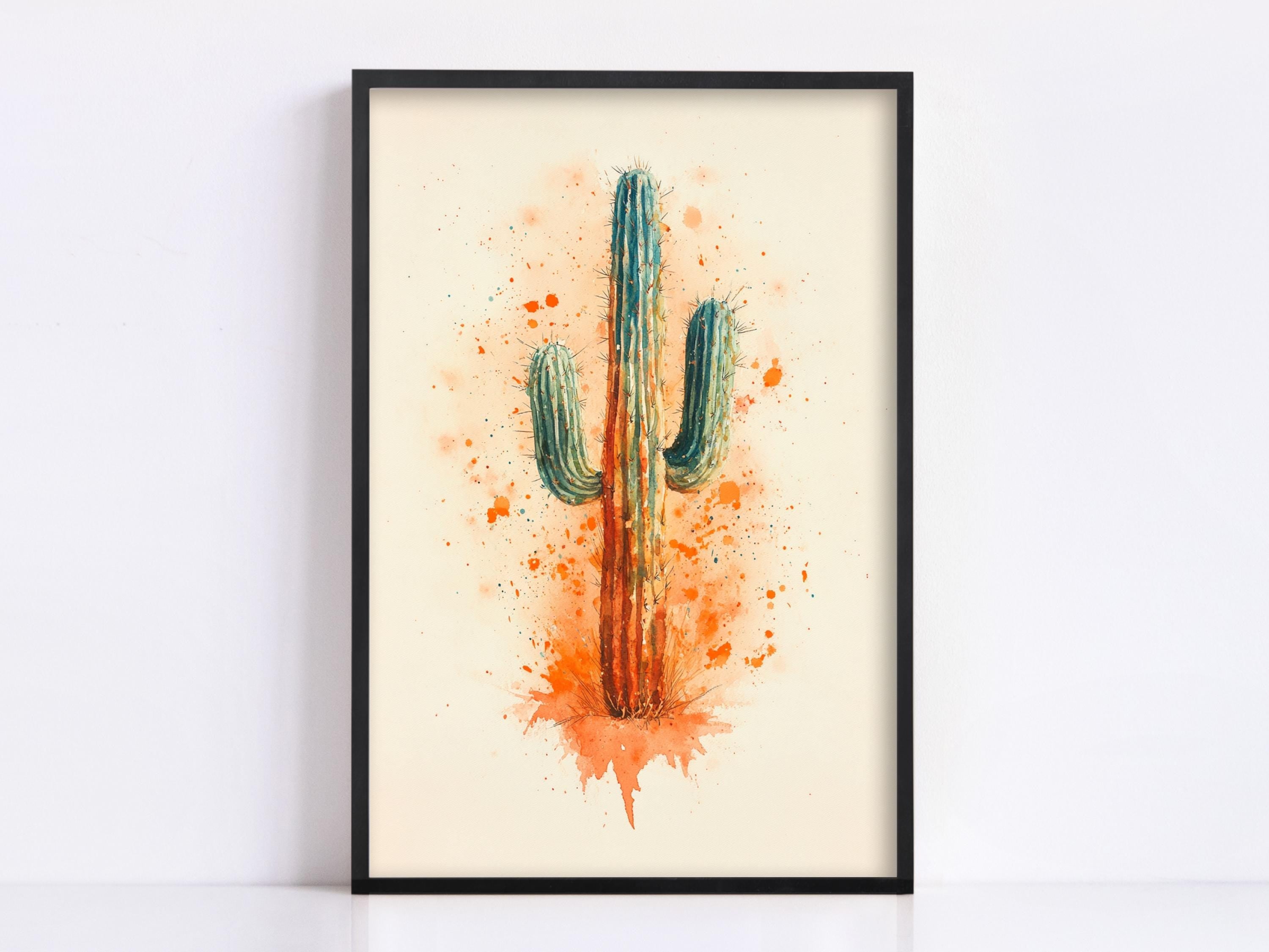 A framed watercolor painting of a cactus with a vibrant orange and green color scheme, set against a light beige background.