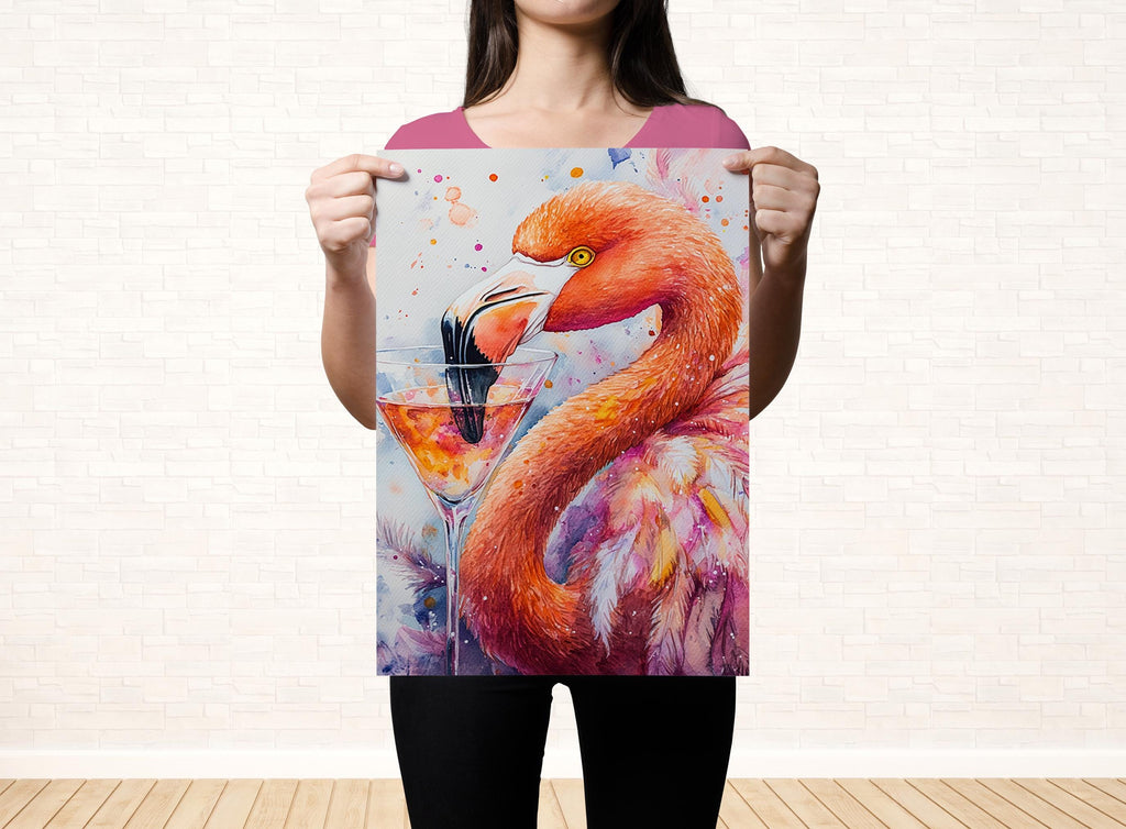 A woman holds up a poster featuring a vibrant painting of a flamingo with a drink in its beak.