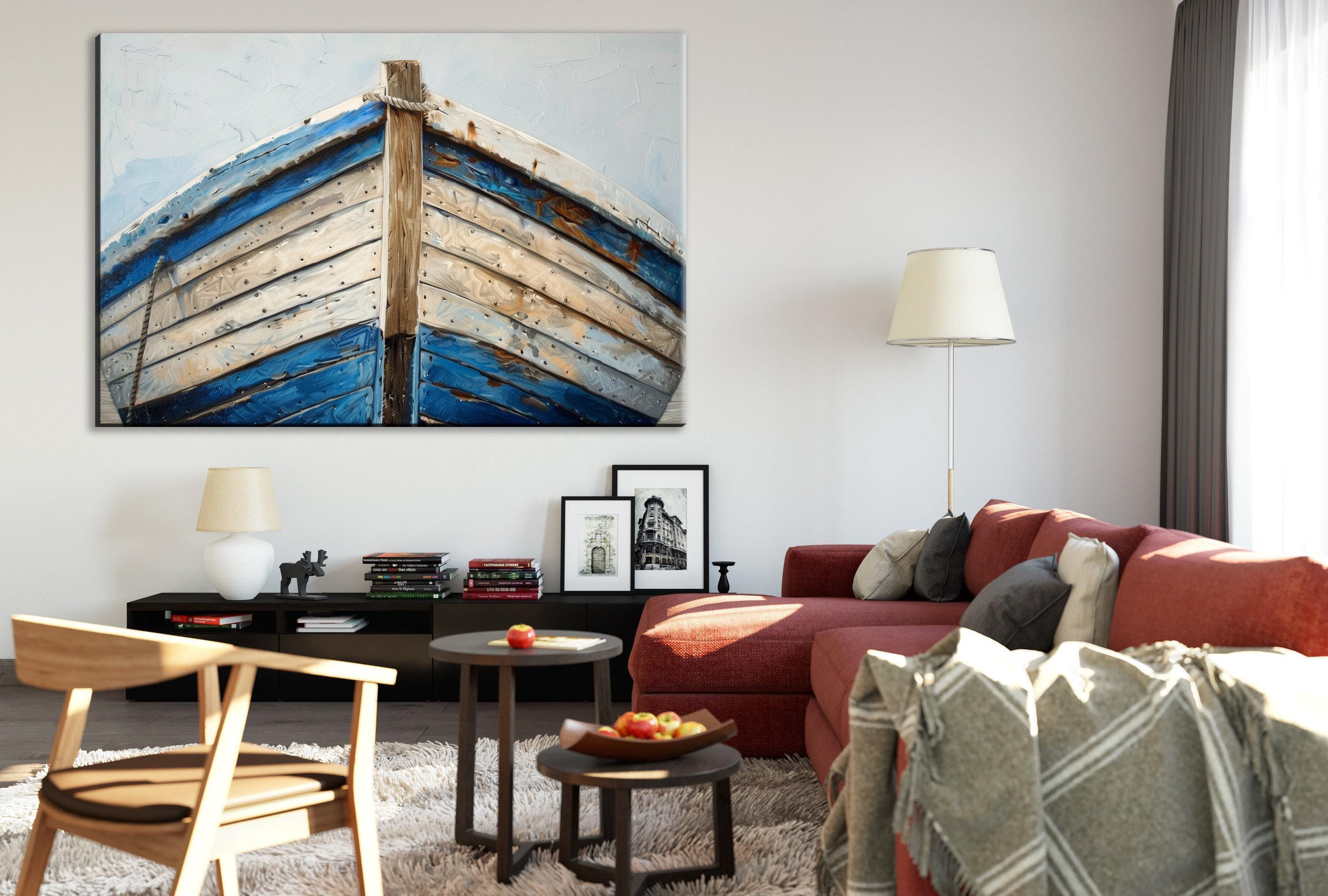a cozy living room with a large blue and white boat painting on the wall, a red sofa, a wooden chair, and a coffee table with a bowl of fruit.