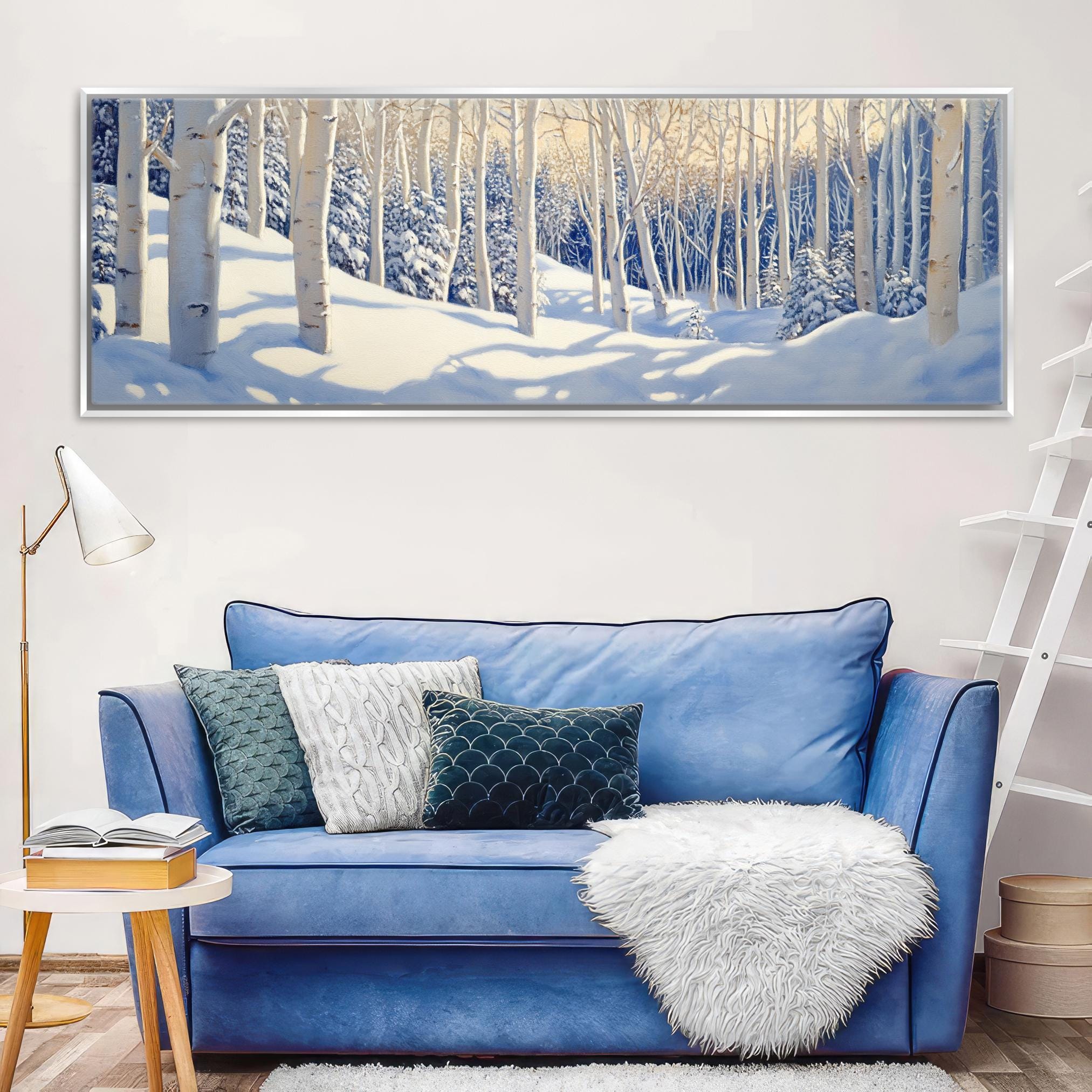 a living room with a blue couch and a painting on the wall