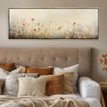 a bed with pillows and a painting above it