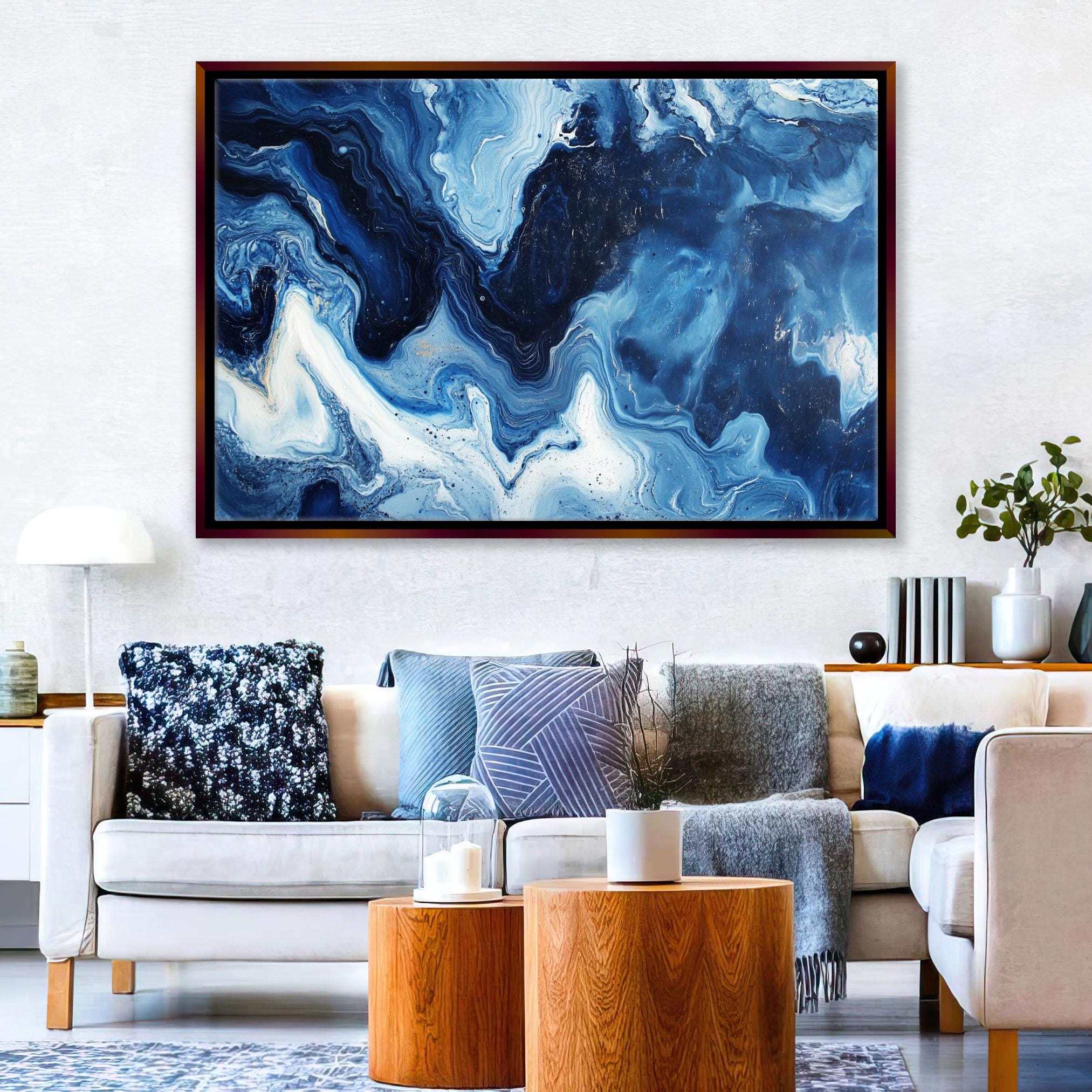 a living room filled with furniture and a painting on the wall