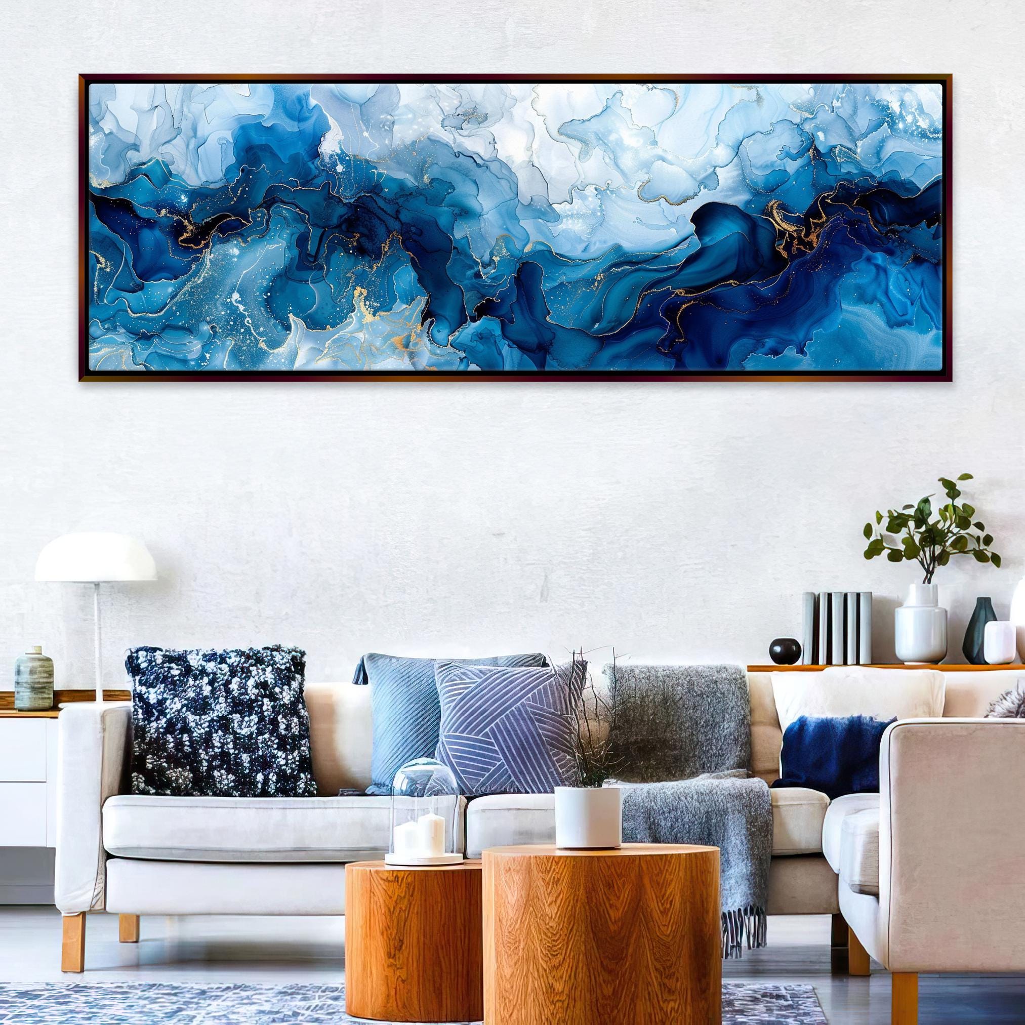 a living room filled with furniture and a painting on the wall