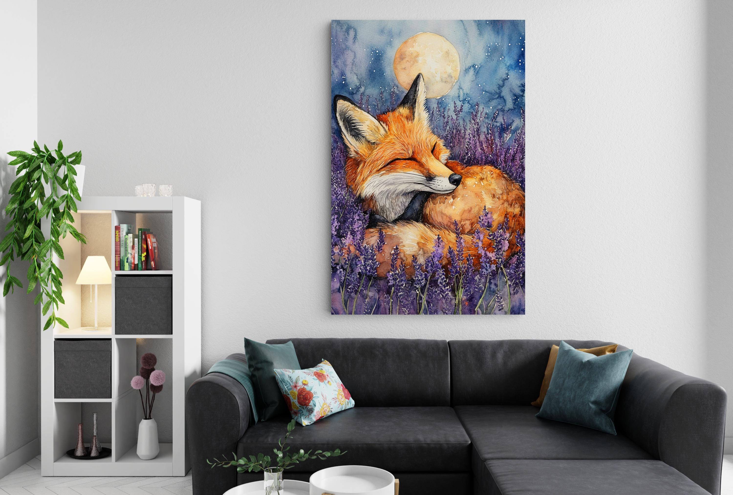 a cozy living room with a large painting of a sleeping fox in a field of purple flowers hanging on the wall above a black couch.