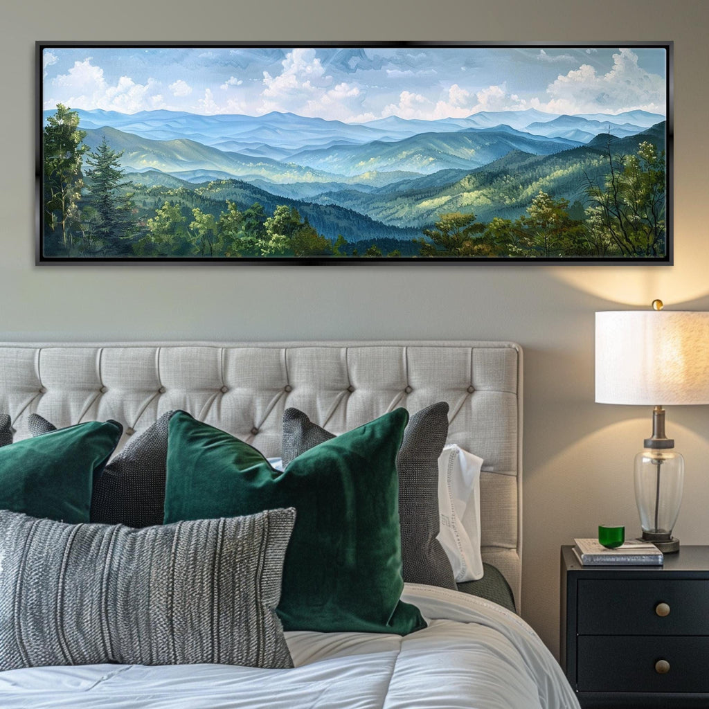 a large landscape painting hanging on a wall above a bed with white tufted headboard. The painting depicts a scenic mountain range with lush green forests and a blue sky with white clouds.