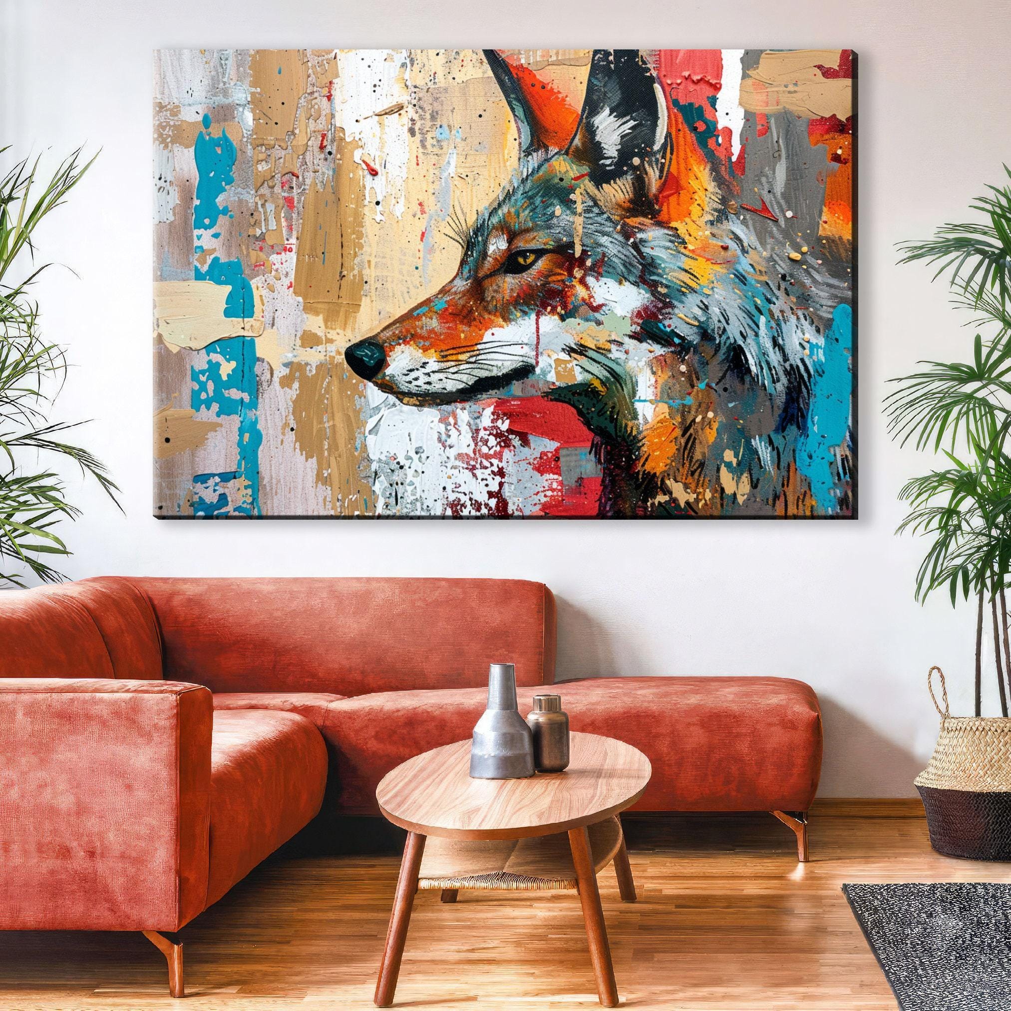 a large, colorful painting of a fox's head on the wall above a red sofa in a living room setting.