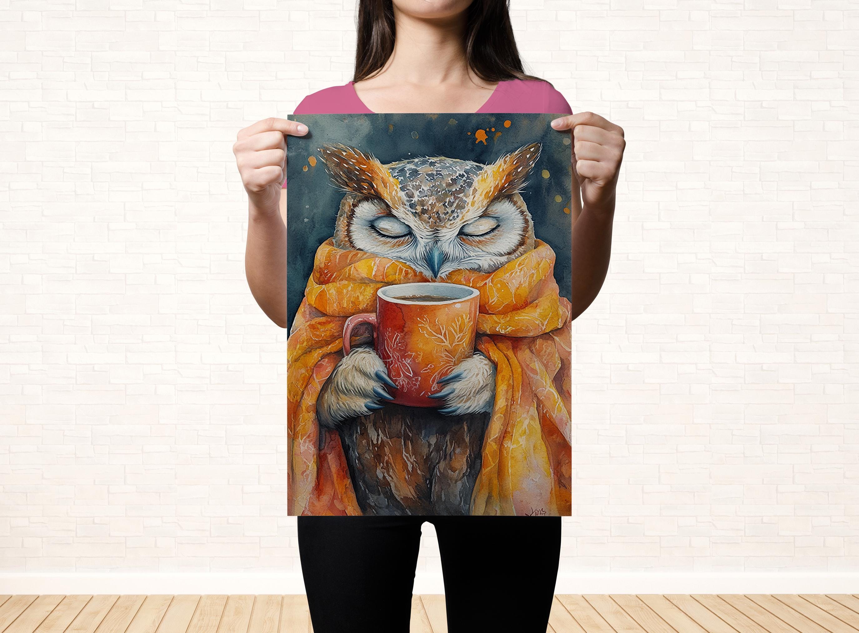 A woman holds up a poster featuring an owl wearing a scarf and holding a mug, with a dark background and a warm, inviting color palette.