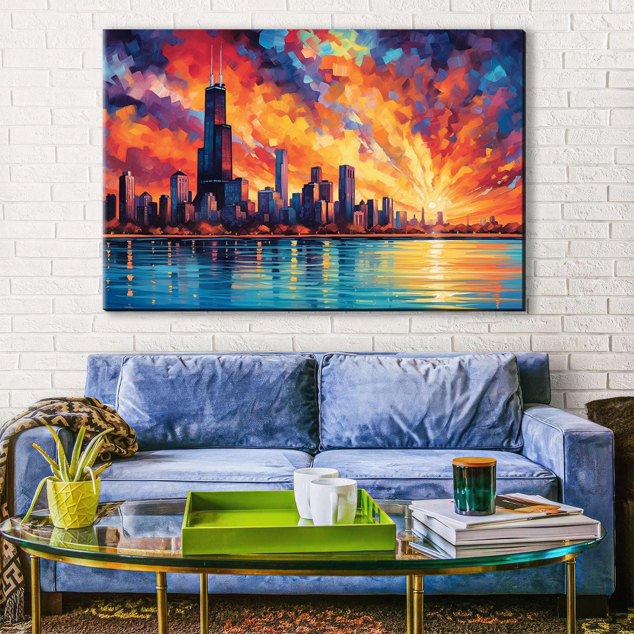 a large painting of a city skyline with a colorful sunset over the water, hanging on a white brick wall above a blue couch with a glass coffee table in front of it.