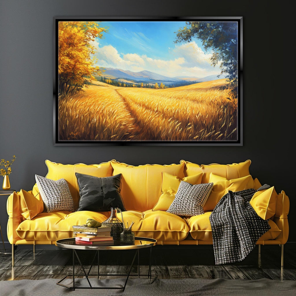 a large painting of a field with golden wheat, hanging on a wall above a yellow sofa with patterned throw pillows.