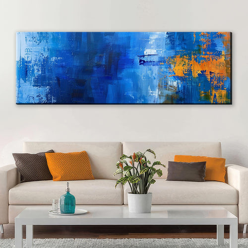 a living room with a white couch and a blue painting on the wall