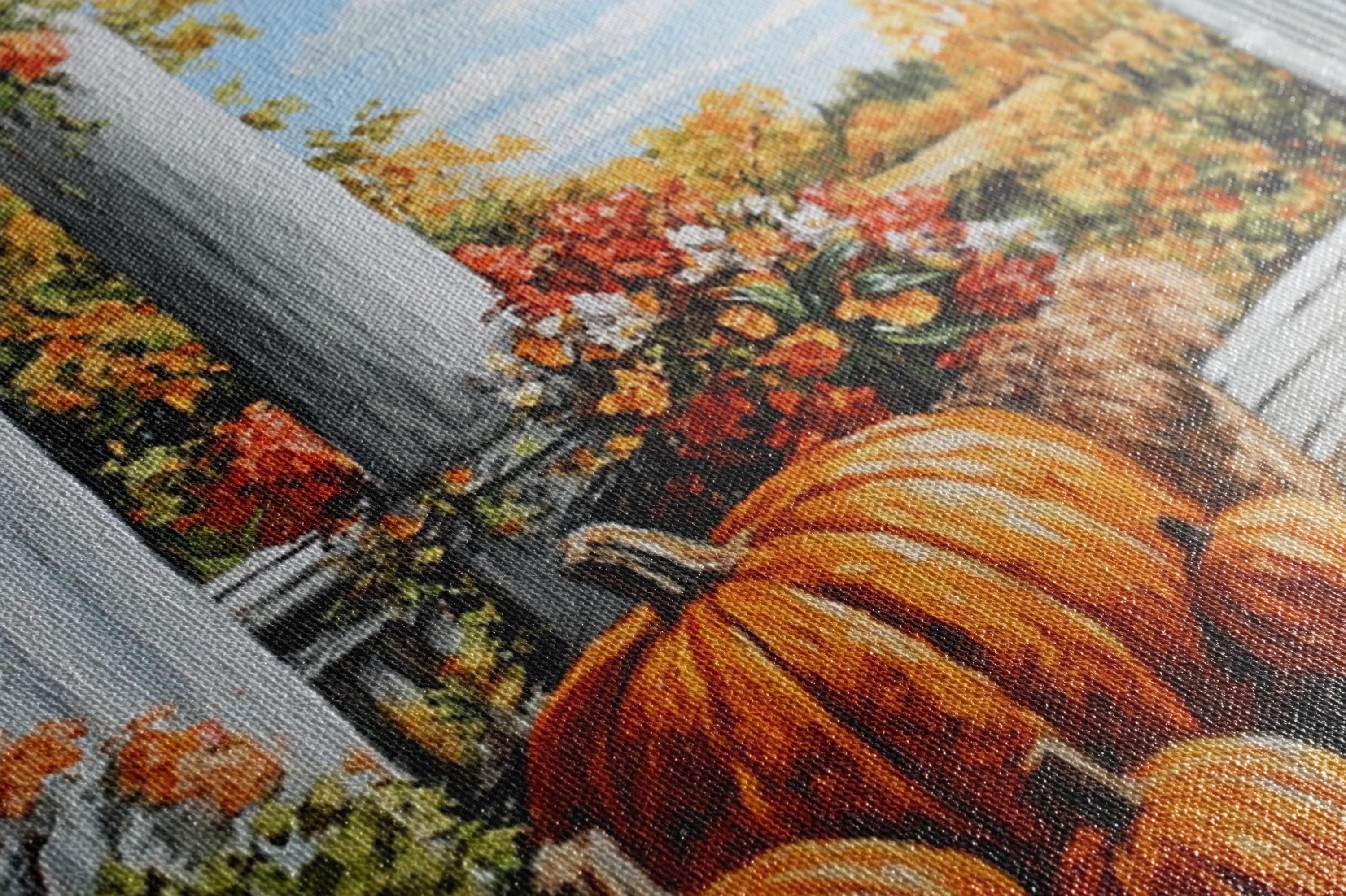 The image is a close-up of a painting or embroidery depicting a vibrant autumn scene with a large orange pumpkin, colorful flowers, and a wooden fence.
