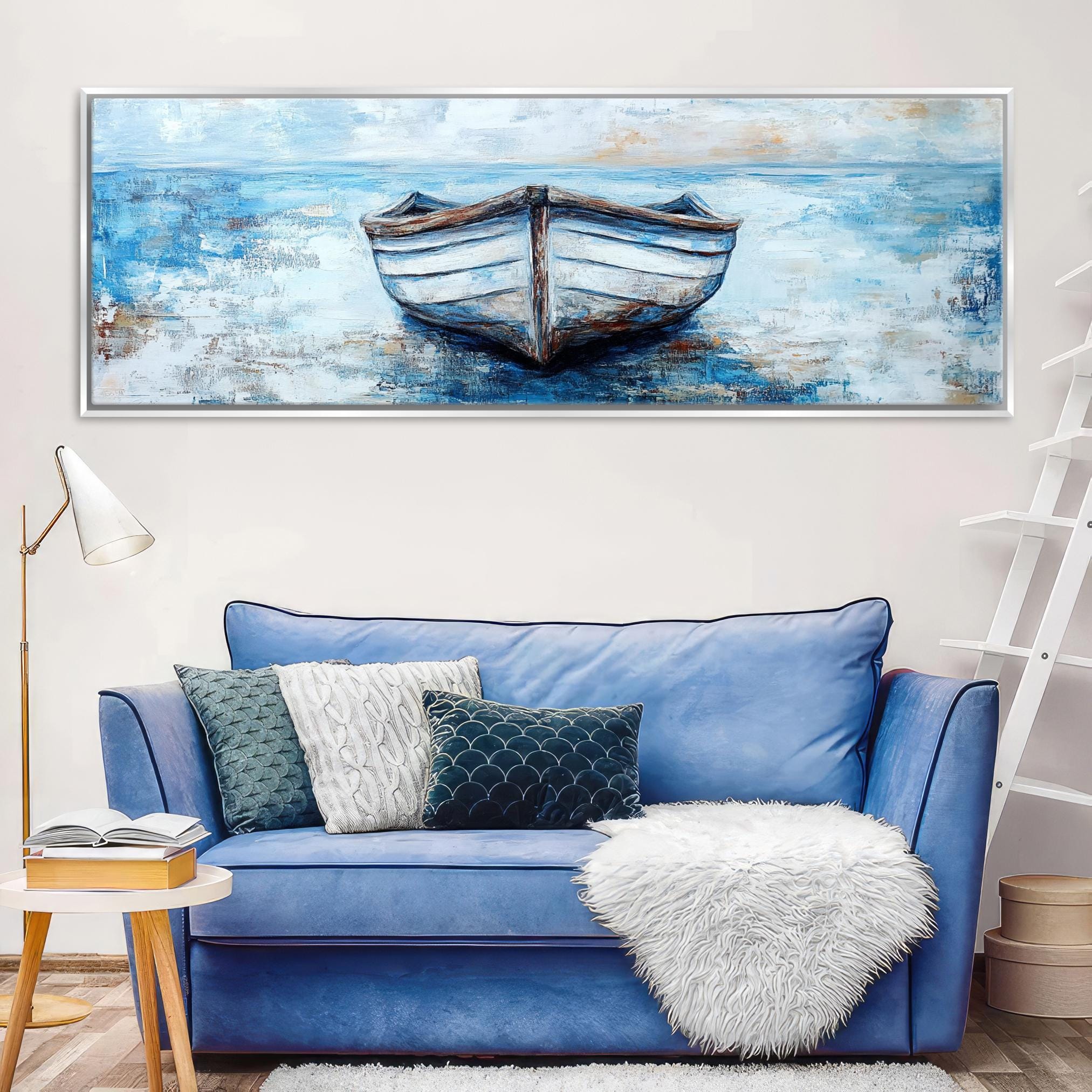 a blue couch with a painting of a boat on it
