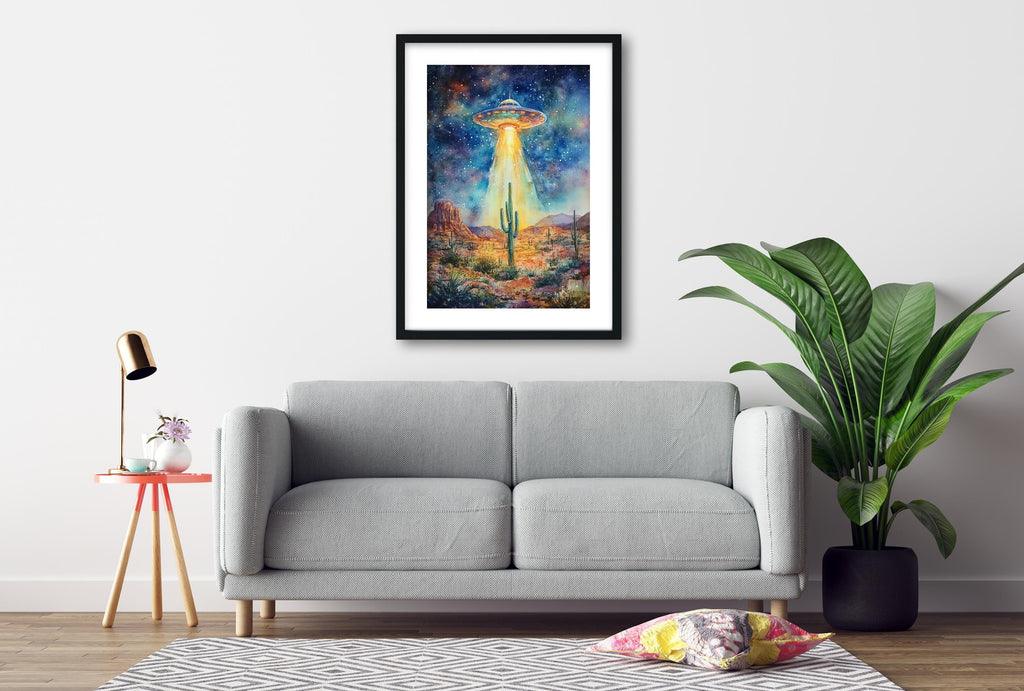 a gray sofa, a framed painting of a desert landscape with a cactus and an alien spacecraft, and a potted plant in a living room setting.