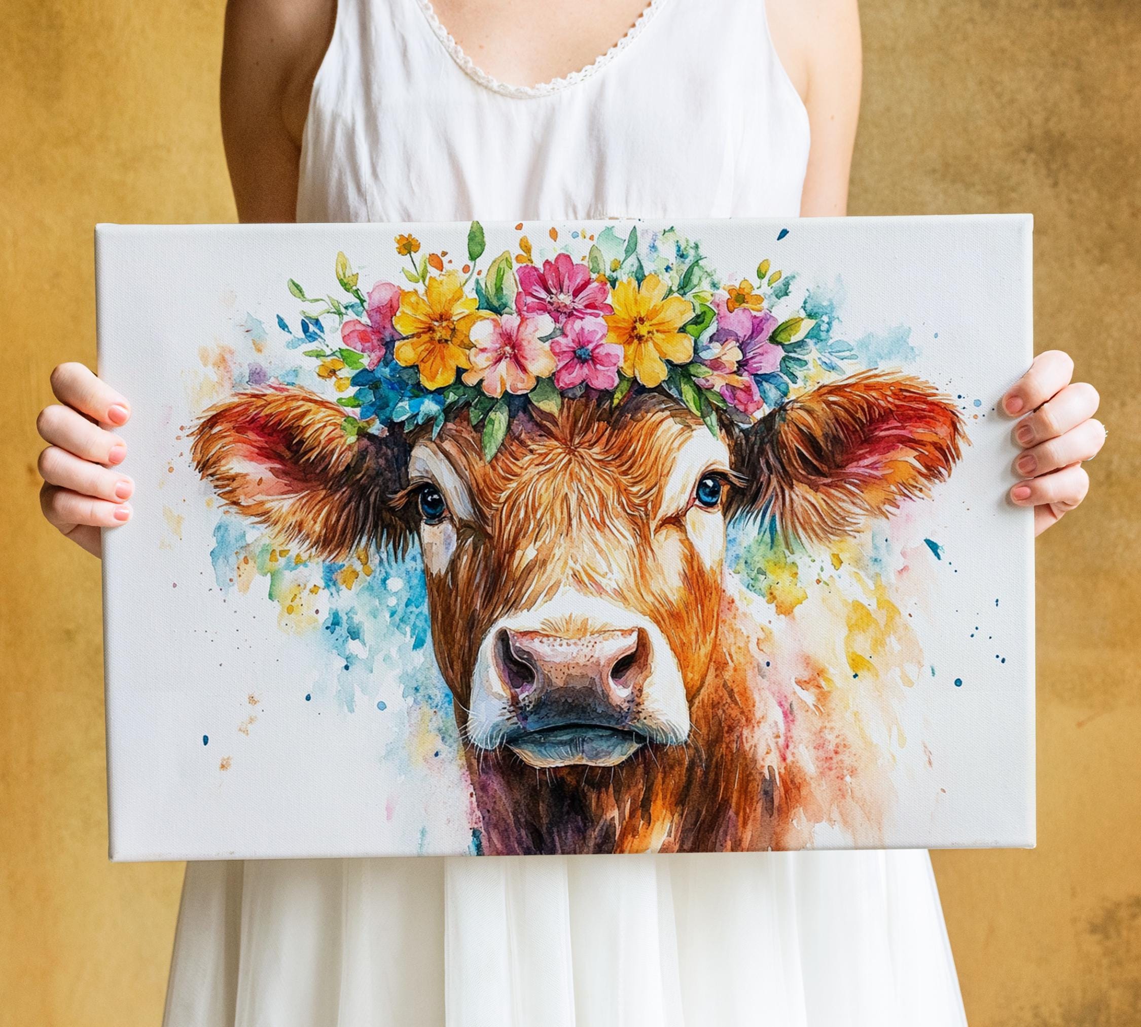 A woman holds a canvas featuring a cow with a flower crown on its head.