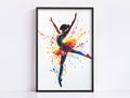 A framed painting depicting a ballerina in a dynamic pose, with her arms raised and surrounded by splashes of color.