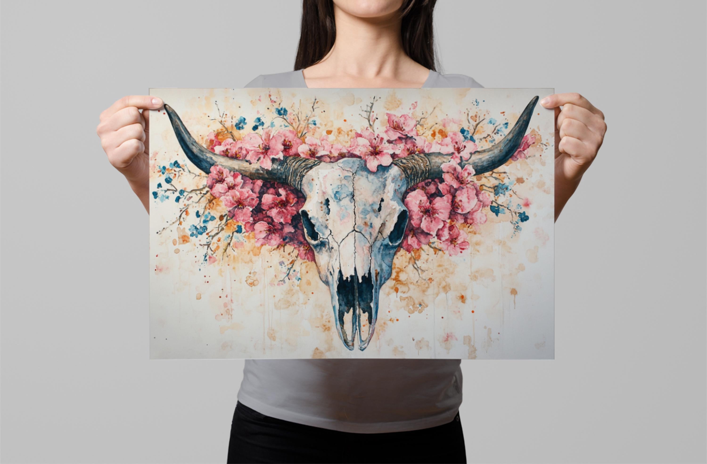 A woman holds up a framed print featuring a colorful illustration of a skull with horns and flowers.
