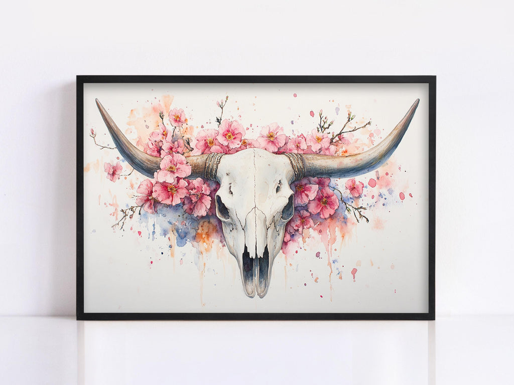 A framed painting depicting a white skull with large horns surrounded by pink flowers.