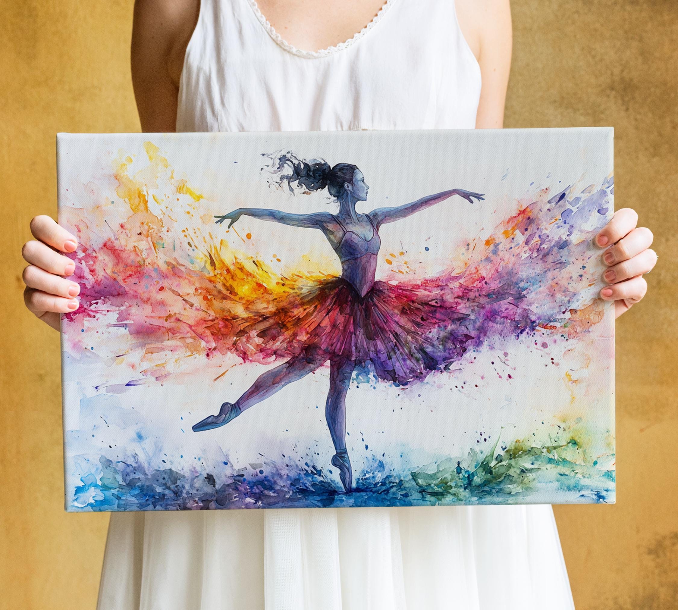 A woman is holding a colorful painting of a ballerina in a tutu, with vibrant splashes of color surrounding her.