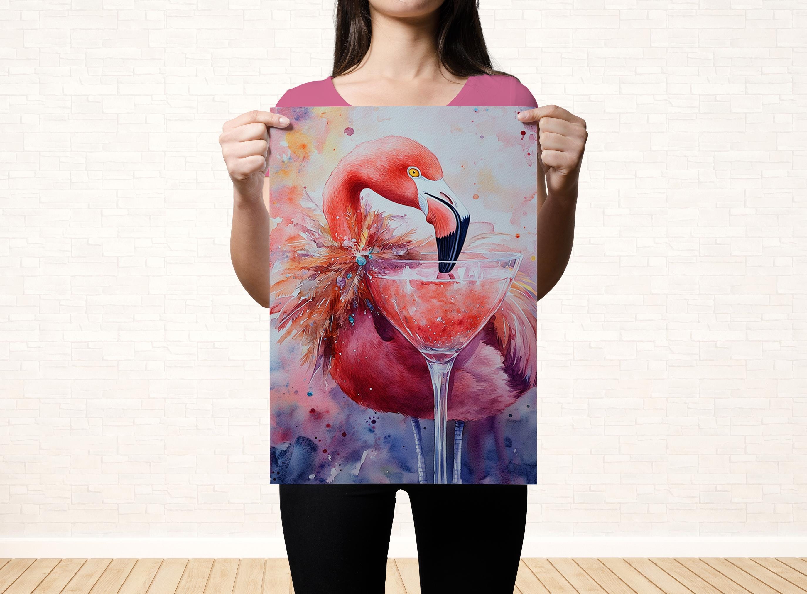 A woman holds up a framed painting of a flamingo with a martini glass in front of it.