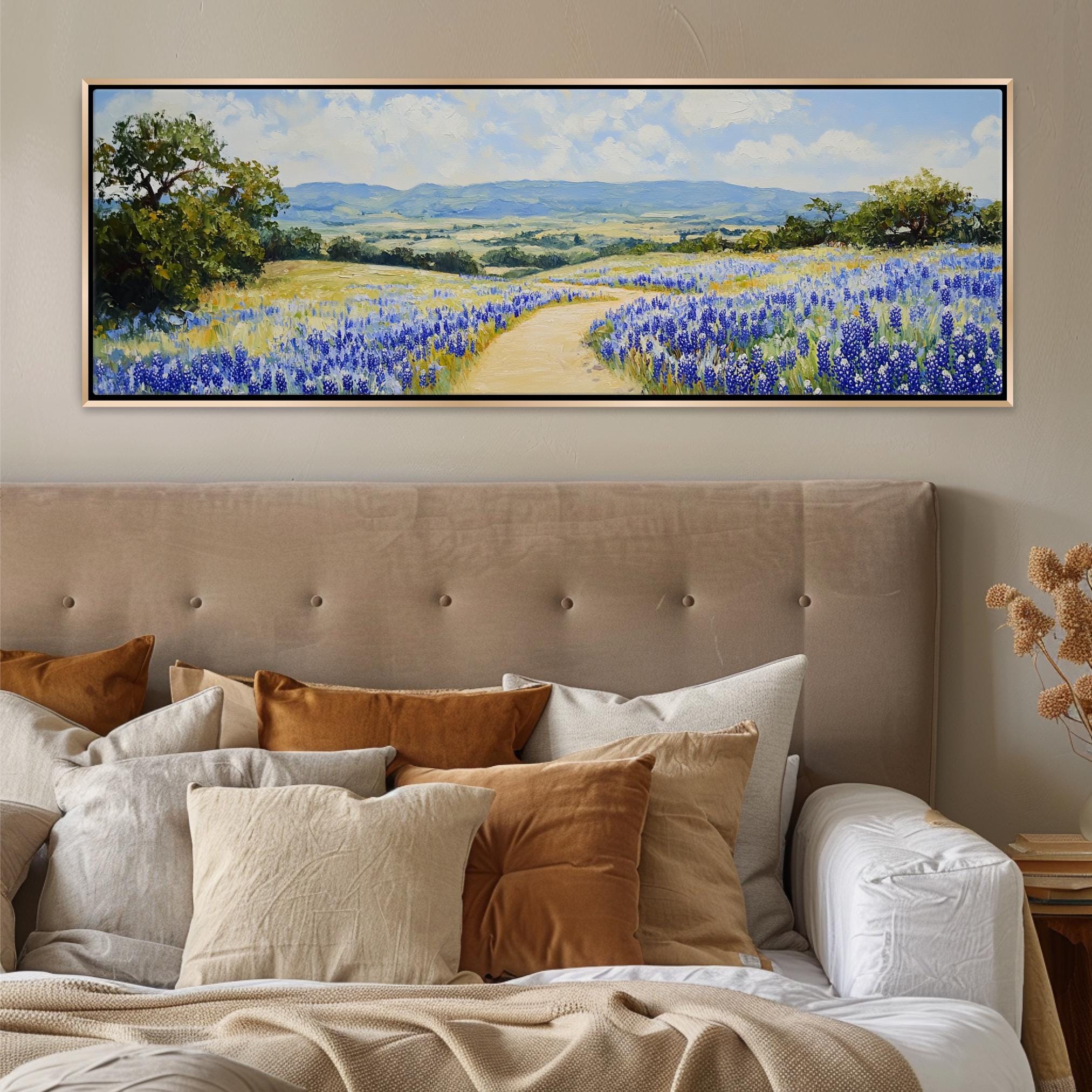 a painting of a field of flowers on a wall above a bed