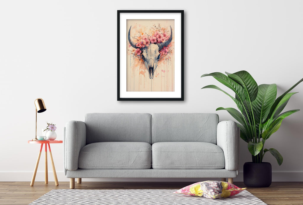 a gray sofa, a framed artwork of a skull with flowers, a small table with a lamp, and a potted plant, all arranged in a living room setting.
