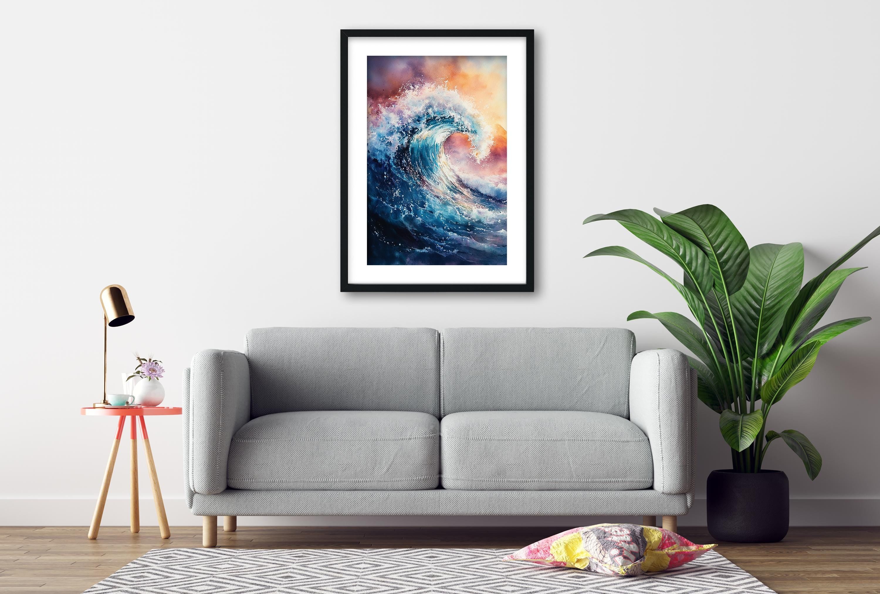 a gray sofa, a framed painting of a wave, a small table with a lamp, and a potted plant, all arranged in a living room setting.