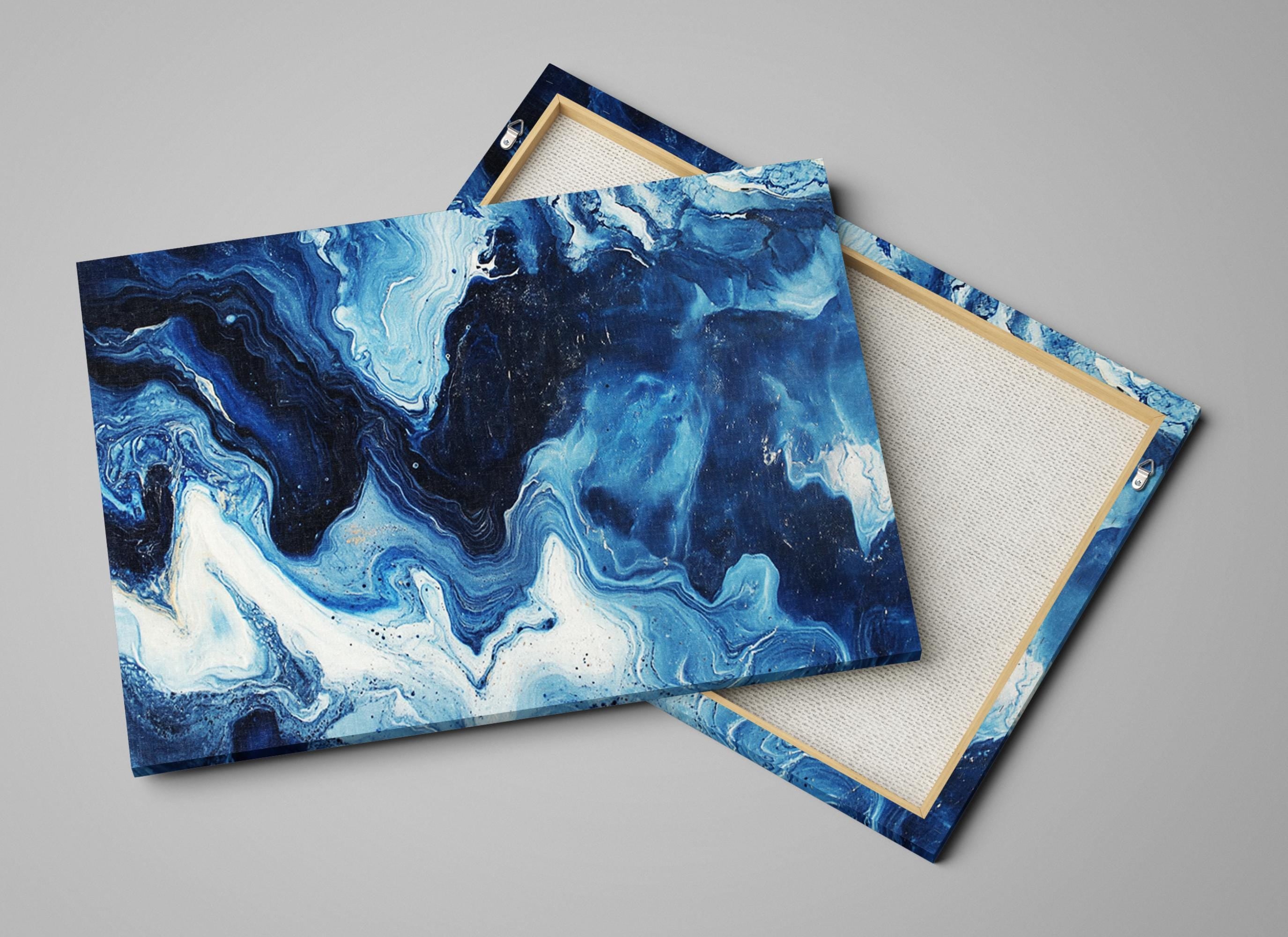 a pair of blue and white marbled coasters