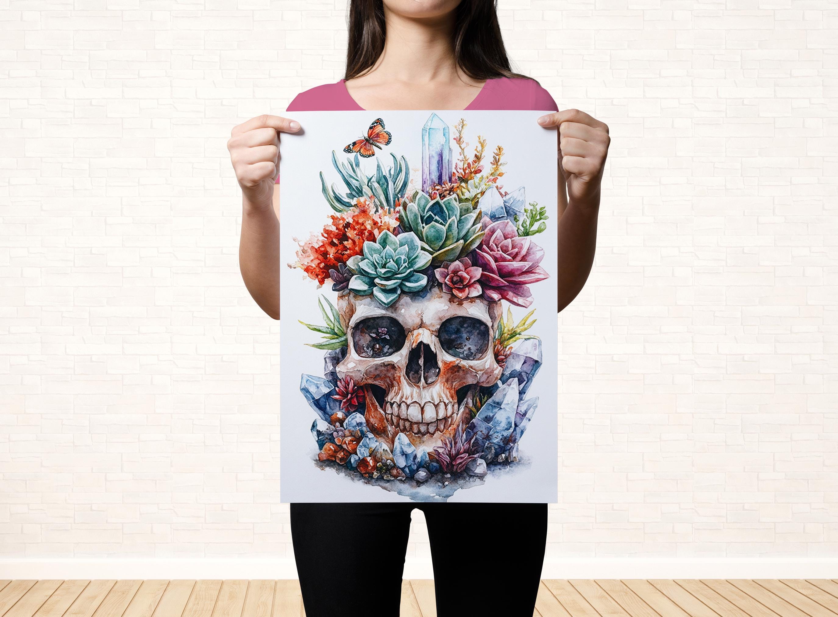 A woman holds up a colorful poster featuring a skull surrounded by various flowers and plants.
