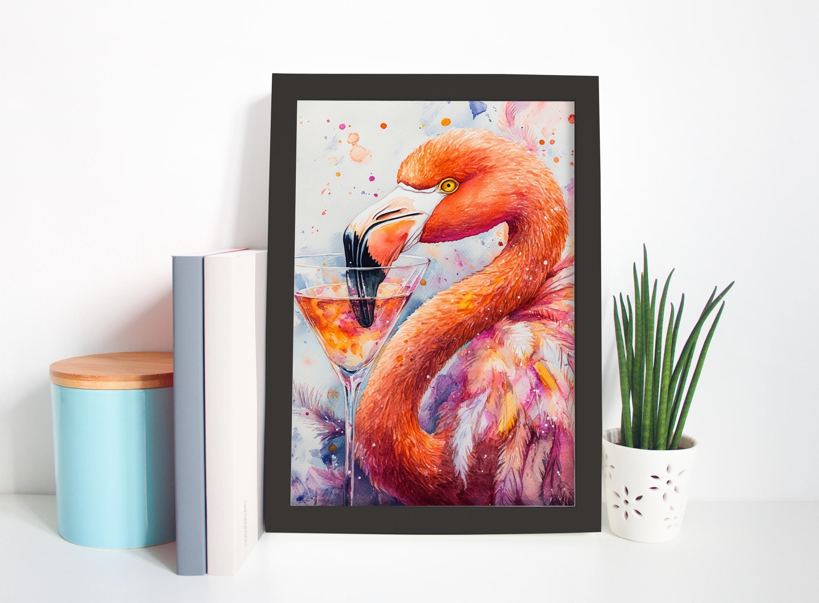 a framed painting of a flamingo with a drink in its beak, placed on a shelf next to a potted plant and some books.