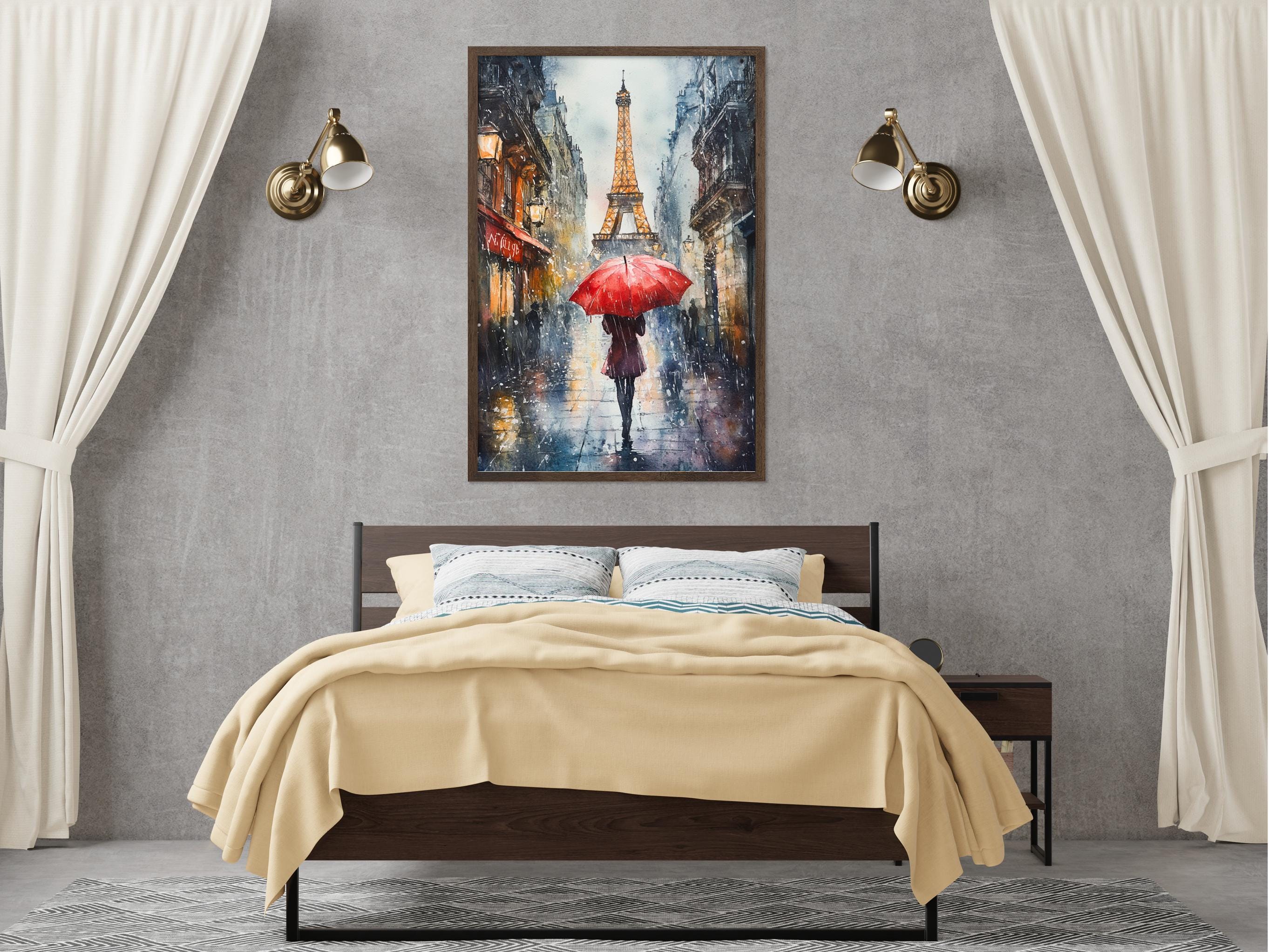 a bedroom with a large bed, a nightstand, and a framed painting of a person walking with an umbrella in front of the Eiffel Tower.