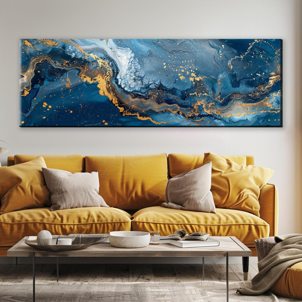a living room with a yellow couch and a large painting on the wall